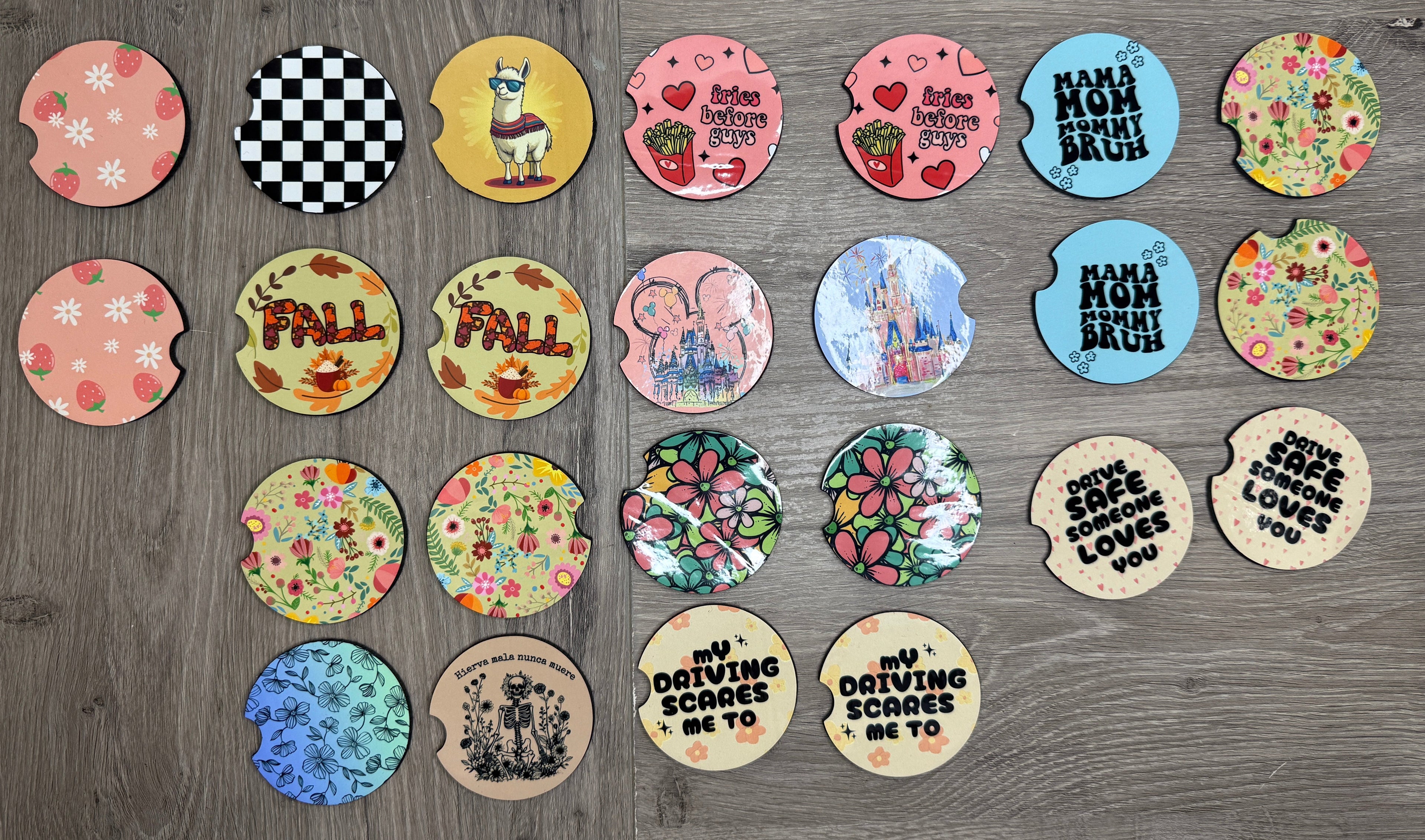Collection of colorful car coasters with various designs on a wooden surface.